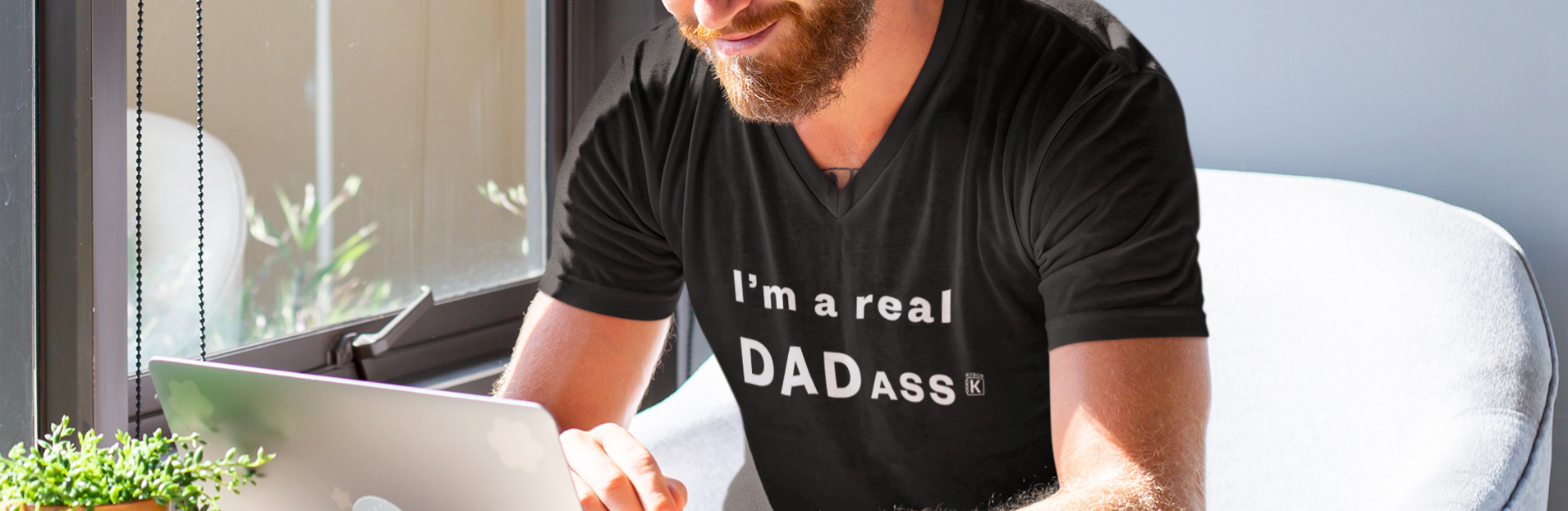 a-man-working-at-his-desk-wearing-a-dadass-t-shirt