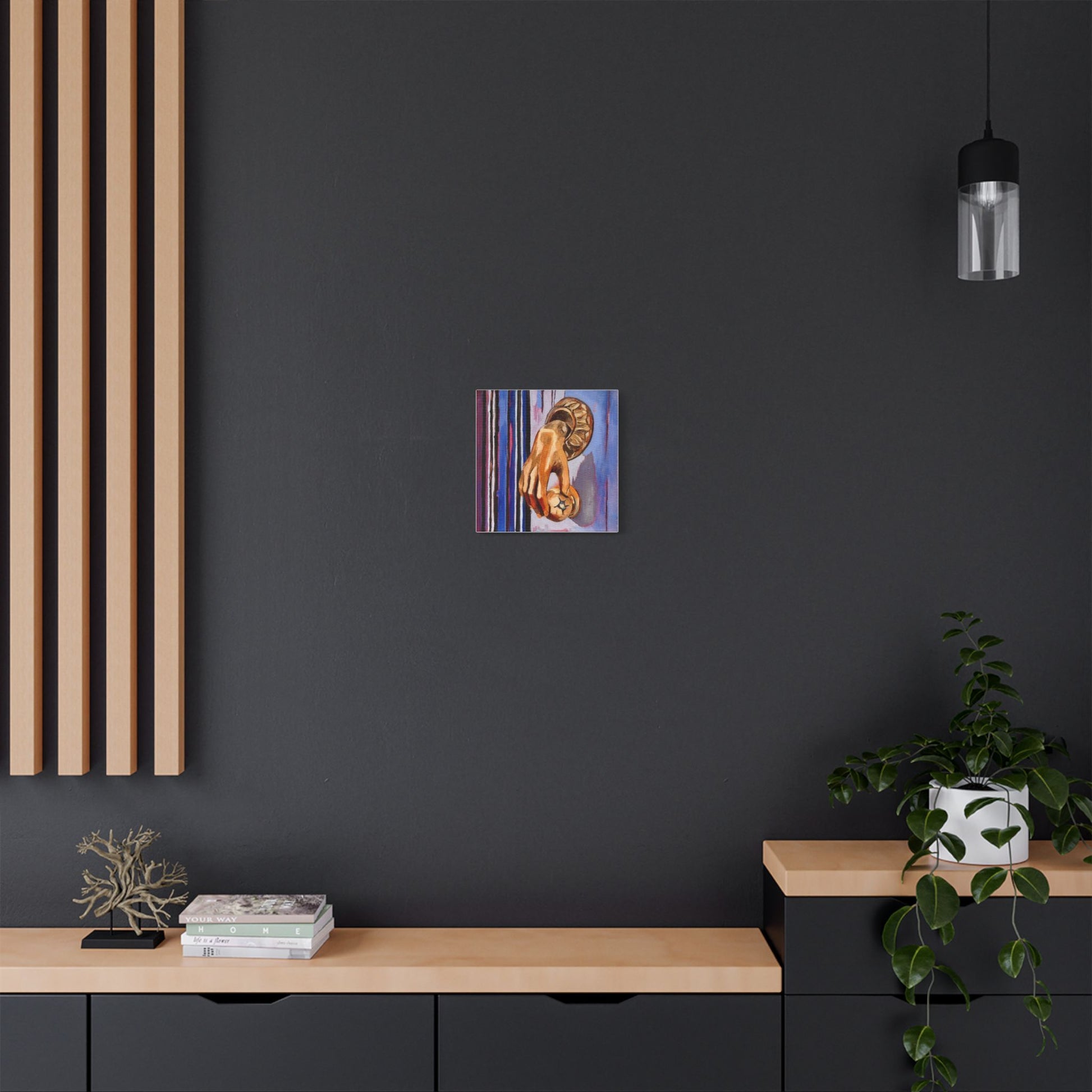 Modern interior with a dark wall, wooden shelf, and abstract artwork.