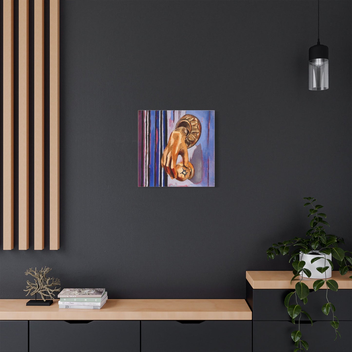 Abstract painting on a dark wall above a wooden shelf with decor items.