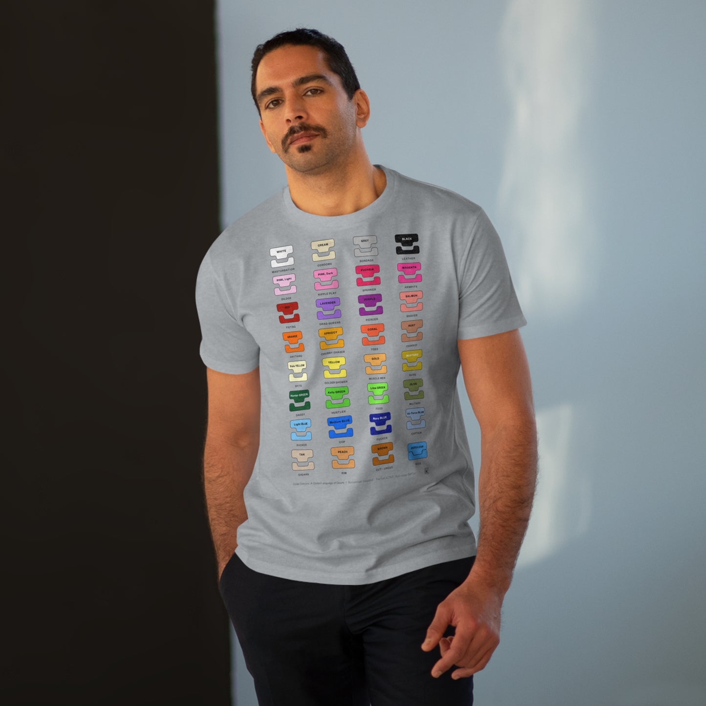 Man wearing a gray t-shirt with colourful graphic design on a gradient background
