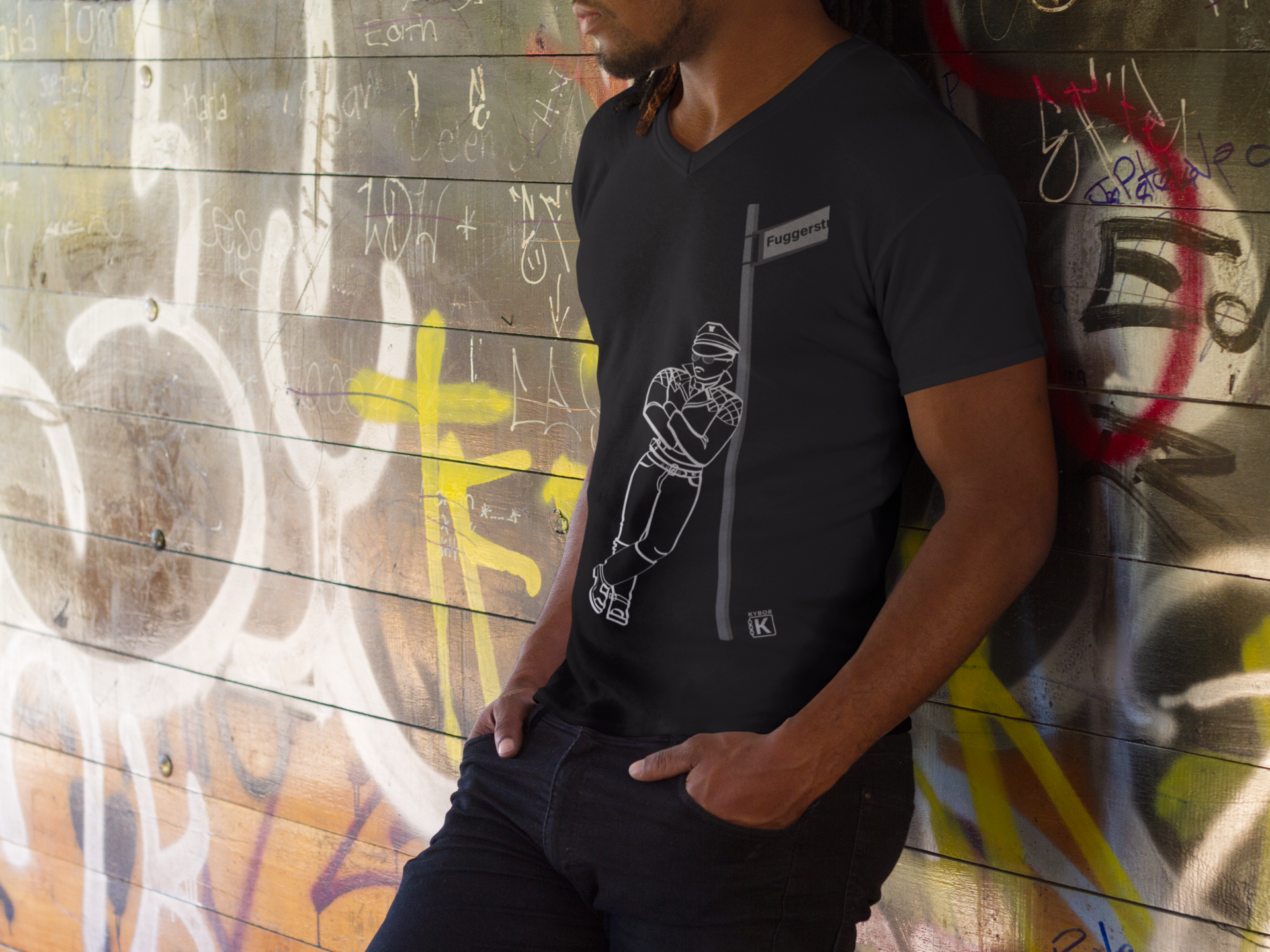 100% Cotton V-Neck T-Shirt - With Graphic Featuring a Leather Man Leaning On A Post At 'Fuggerstrasse'